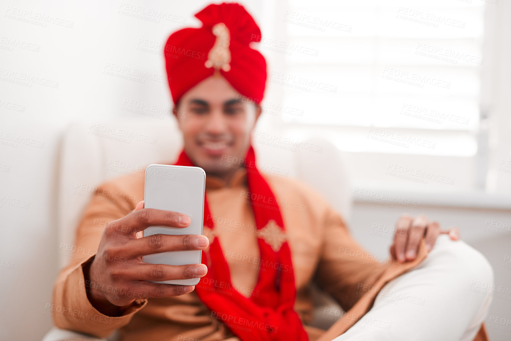 Buy stock photo Shot of a young man using a smartphone on his wedding day
