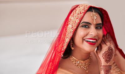 Buy stock photo Shot of a beautiful young woman putting on her earrings in preparation for her wedding