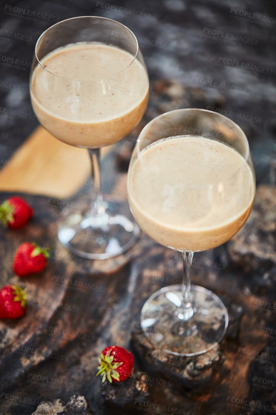 Buy stock photo Shot of a freshly made cream snack served in a glass with strawberries on a table