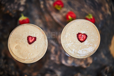 Buy stock photo Shot of a freshly made cream snack served in a glass with strawberries on a table