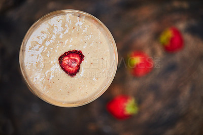 Buy stock photo Shot of a freshly made cream snack served in a glass with strawberries on a table