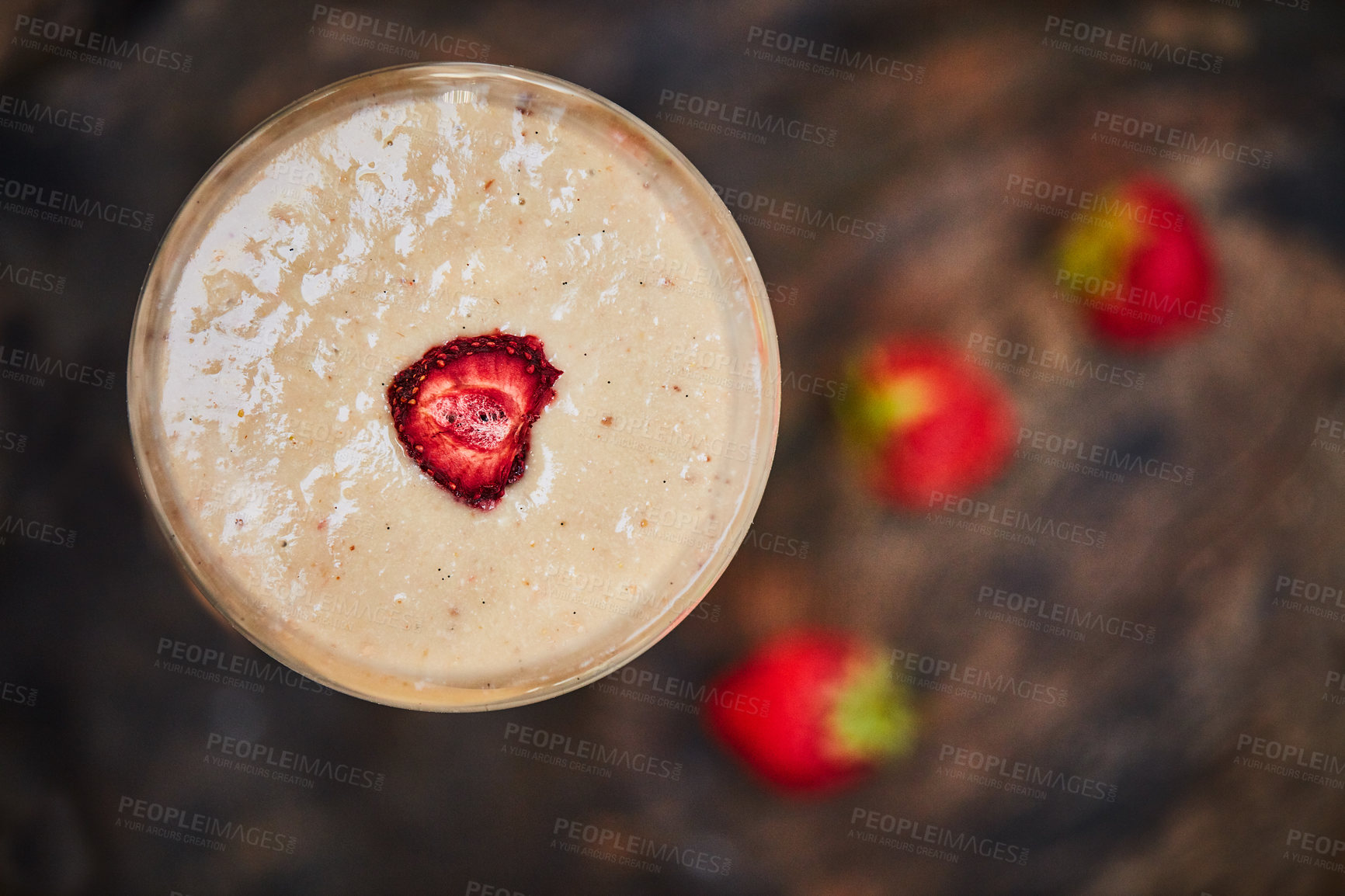 Buy stock photo Shot of a freshly made cream snack served in a glass with strawberries on a table