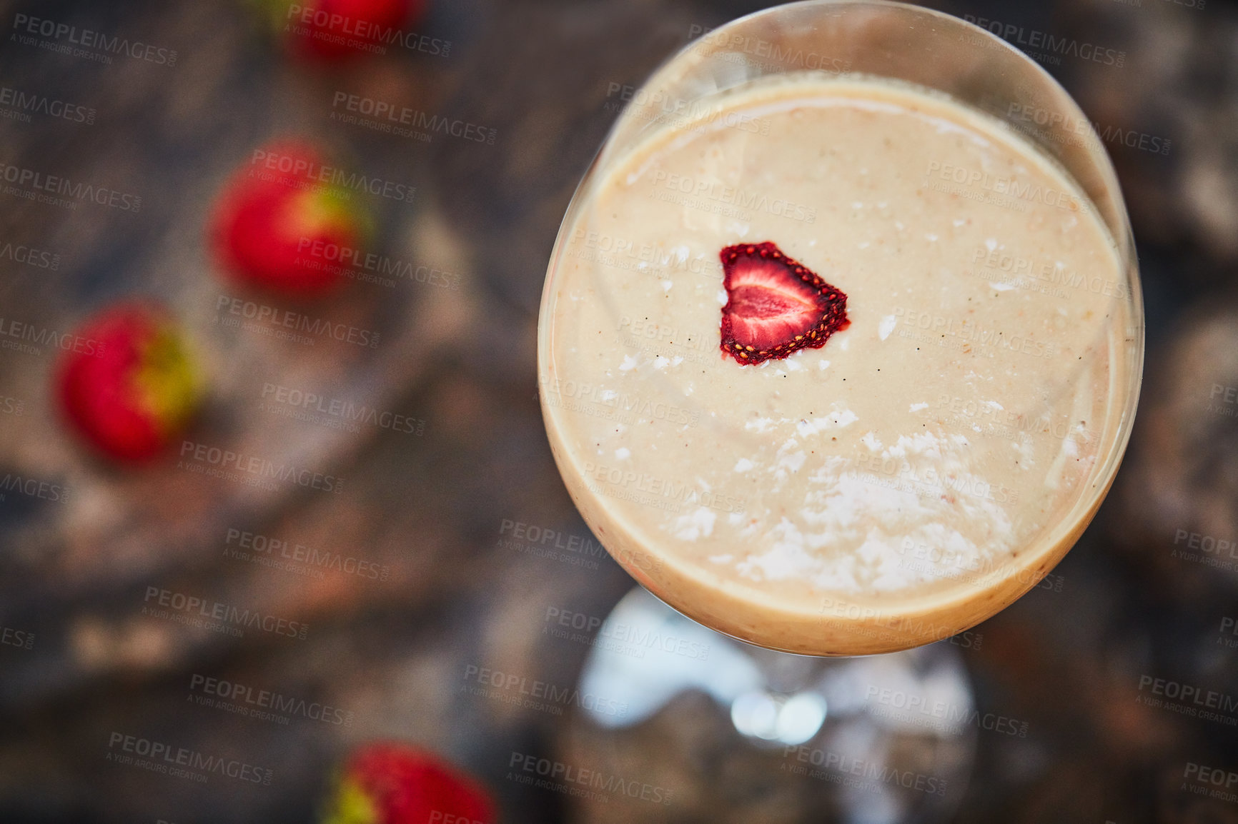 Buy stock photo Shot of a freshly made cream snack served in a glass with strawberries on a table