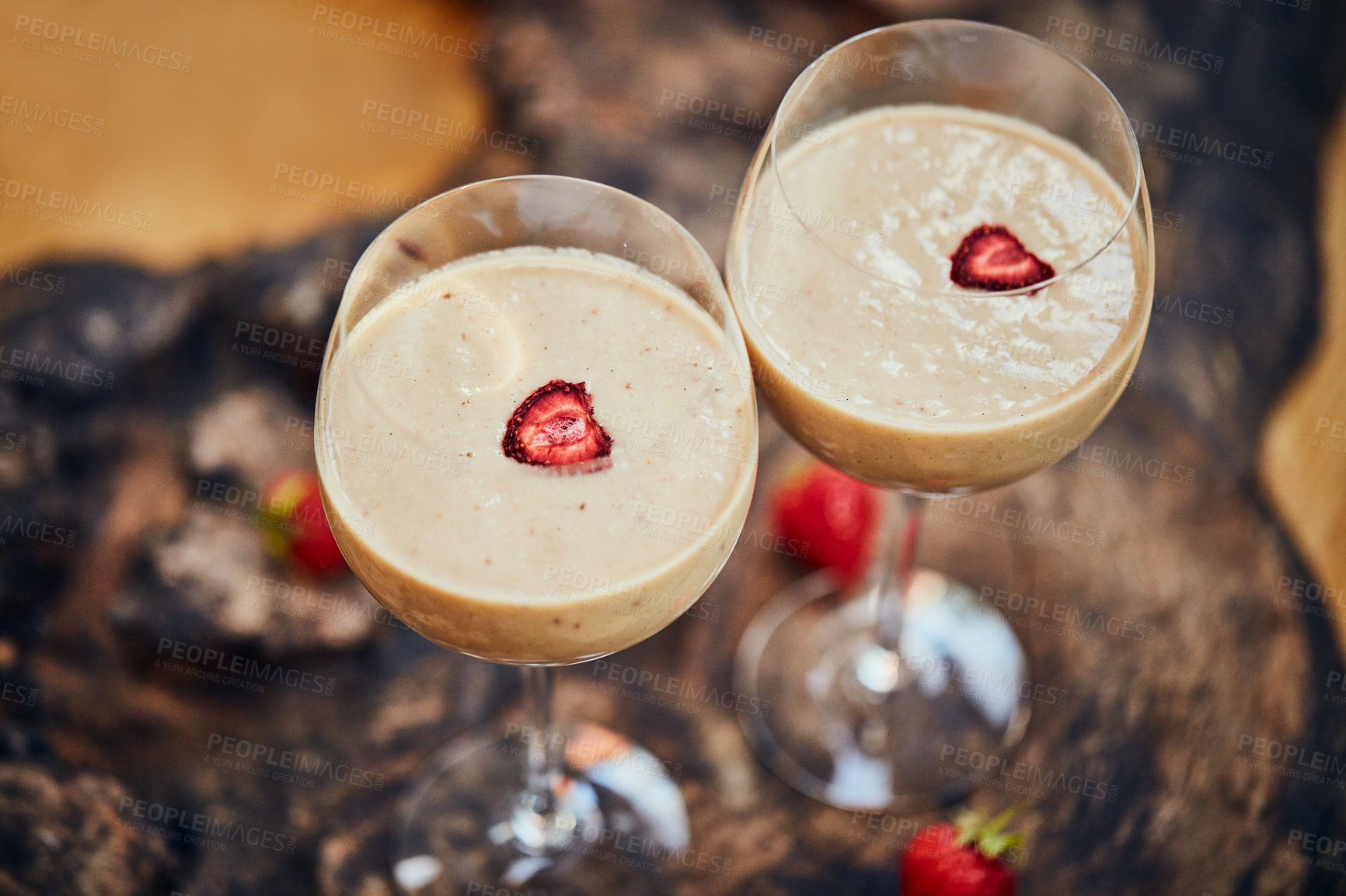 Buy stock photo Shot of a freshly made cream snack served in a glass with strawberries on a table