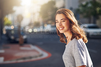Buy stock photo Cropped portrait of an attractive young woman spending her day out in the city