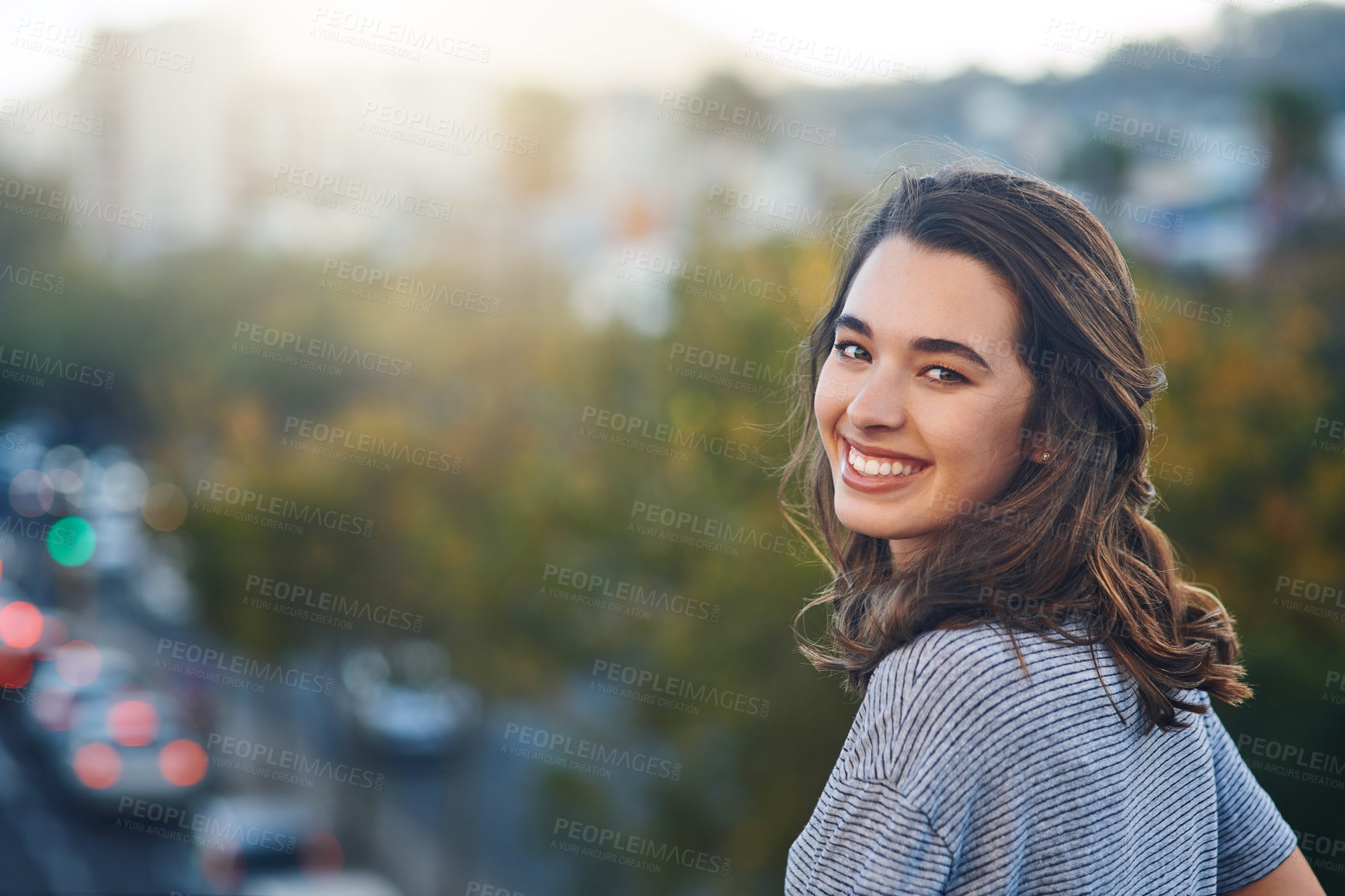 Buy stock photo Rearview portrait of an attractive young woman spending her day out in the city
