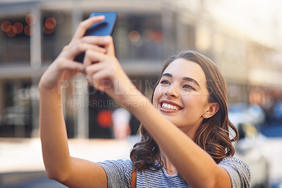 Buy stock photo Girl, smile and travel in city with selfie for profile picture update, social media post and happy memory. Woman, influencer and photography in urban town for holiday adventure and content creation