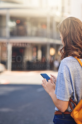 Buy stock photo Girl, phone and student with back in street, texting and travel to college for education with mobile app. Person, woman and smartphone to check bus schedule, taxi or transport to university in Spain