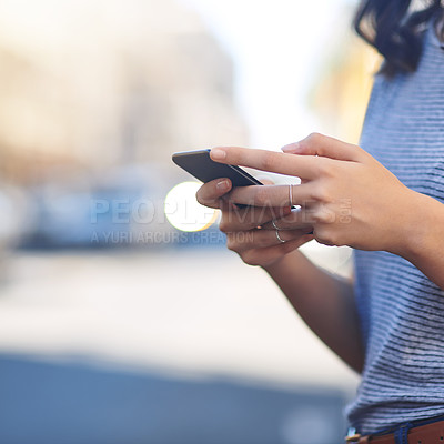 Buy stock photo Hands, phone and texting with person in city to check schedule at bus stop for travel in metro. Smartphone, click and mobile app for taxi, transport and outdoor on urban sidewalk with search in Spain