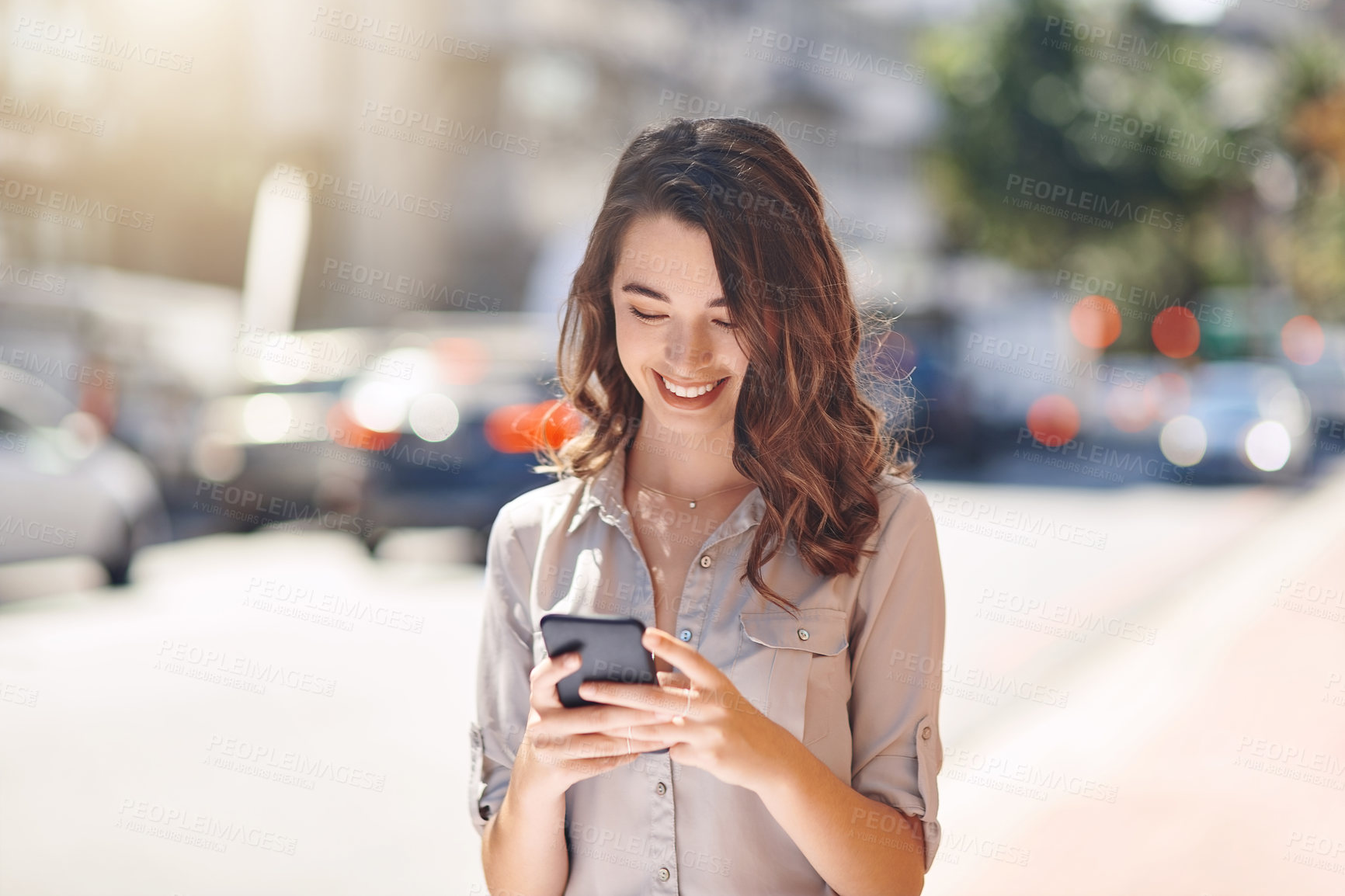 Buy stock photo Cropped shot of an attractive young businesswoman sending text messages during her morning commute to work