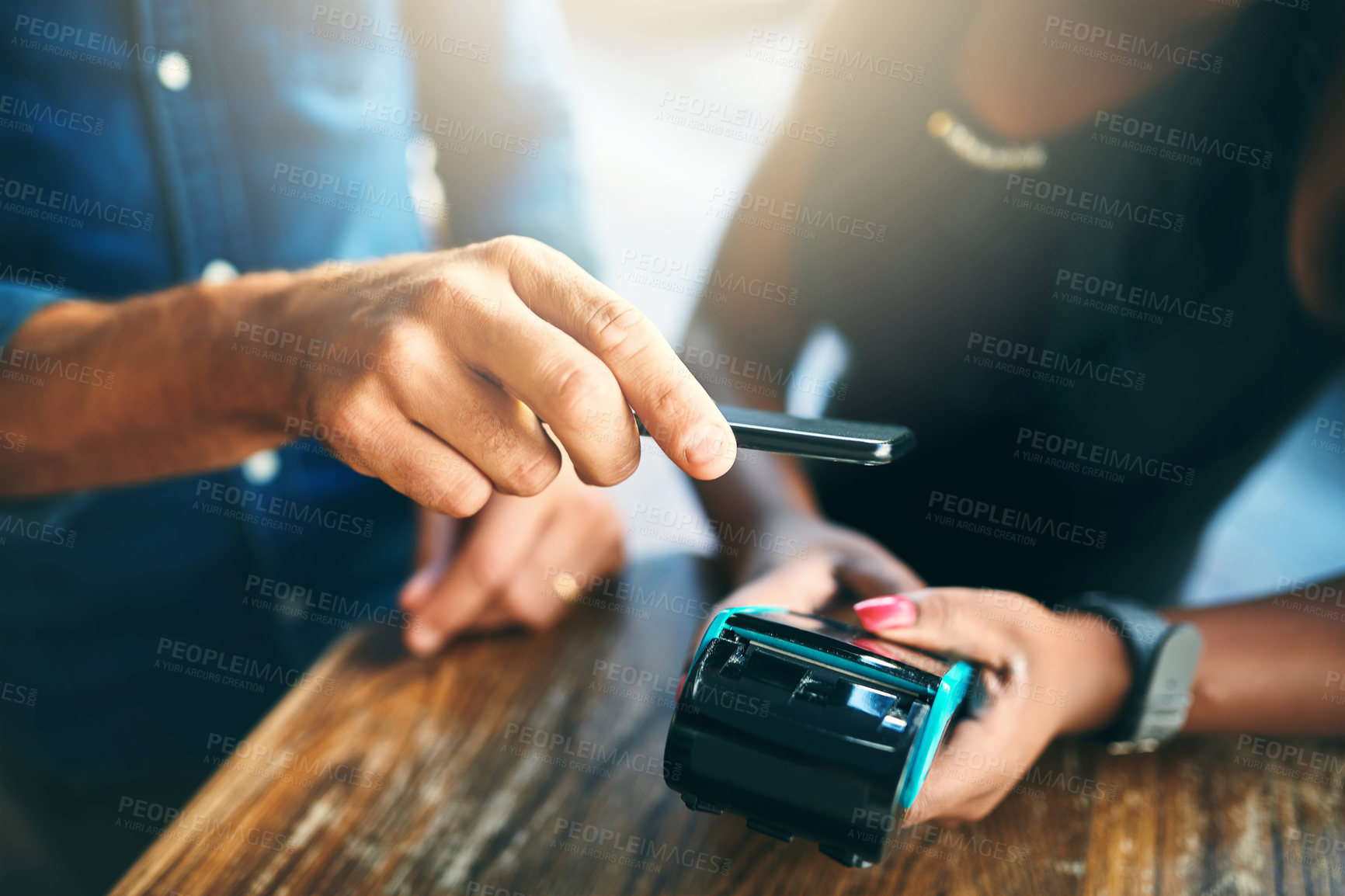 Buy stock photo Cropped shot of an unrecognizable businessman scanning his cellphone to pay for his bill in a cafe