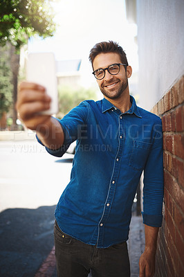 Buy stock photo Cropped shot of a man talking on his cellphone while out in the city