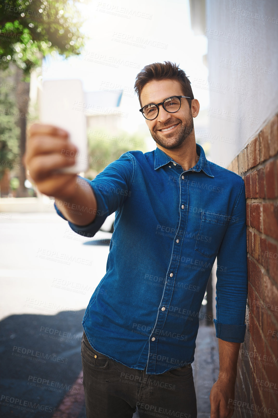 Buy stock photo Happy man, relax and selfie with glasses in city for photography, picture or social media. Young, handsome or male person with smile in joy for memory, capture or outdoor moment in an urban town