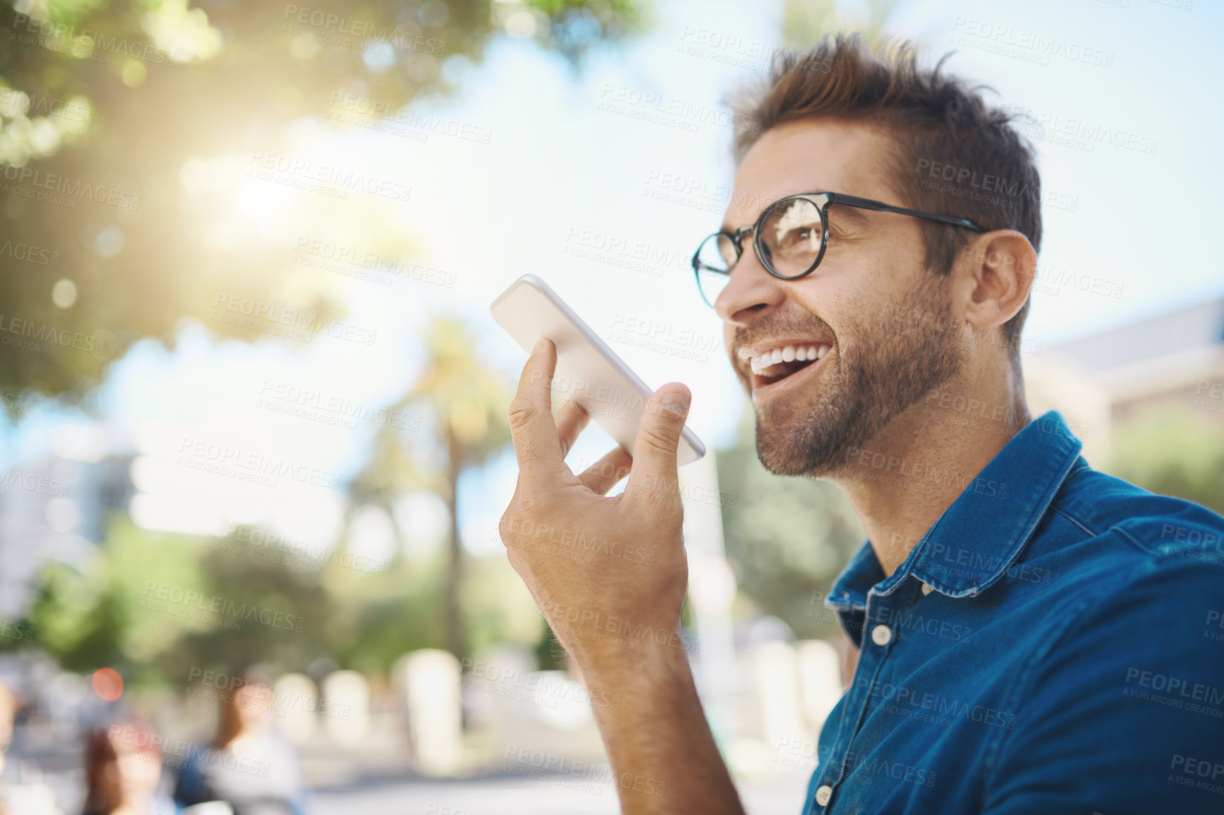 Buy stock photo Happy man, city and phone call with speaker for communication, audio message or voice note. Young, male person or tourist with smile on mobile smartphone for conversation or chating app in urban town