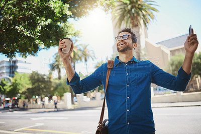 Buy stock photo Shot of a man looking cheerful while holding a coffee and his cellphone