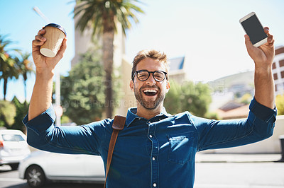Buy stock photo Shot of a man looking cheerful while holding a coffee and his cellphone
