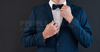 Buy stock photo Cropped shot of an unrecognizable bridegroom adjusting his bowtie in preparation for his wedding