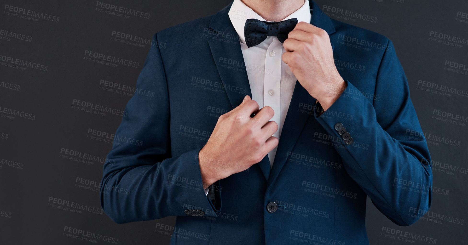 Buy stock photo Fixing bowtie, man and hands in suit for professional, salesman or groom in studio. Gentleman, formal fashion and black background for job interview, business and financial advisor in corporate