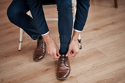 Buy stock photo Cropped shot of an unrecognizable bridegroom tying his shoelaces in preparation for his wedding