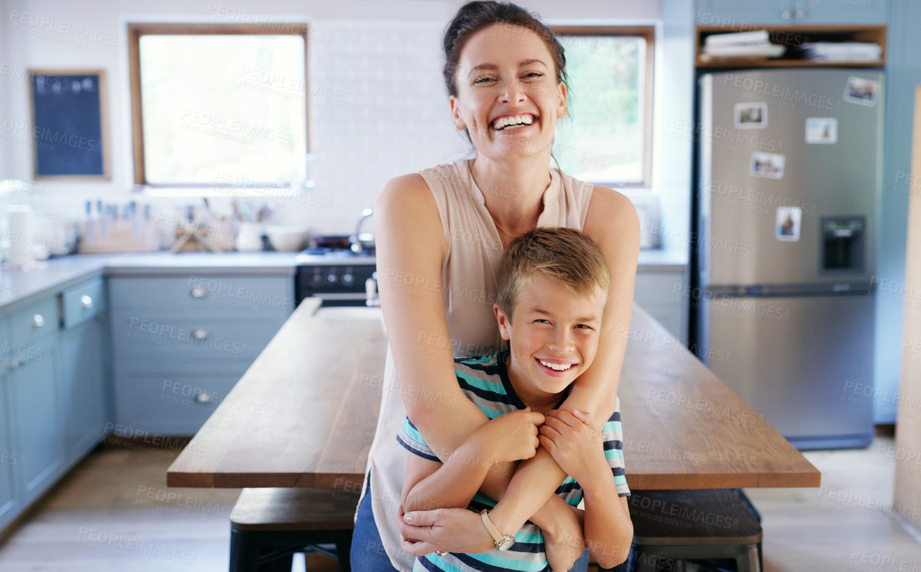 Buy stock photo Portrait smile, mom and son with hug for healthy relationship, security and support in family home. Face, mother and boy child with happy embrace in kitchen for safety, bonding trust and mothers day