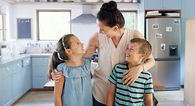 Buy stock photo Cropped shot of an affectionate young mother spending time with her two kids in their kitchen at home