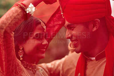 Buy stock photo Wedding, romance and red veil with a couple together in celebration of love at a ceremony. Happy, marriage or islam with a hindu bride and groom getting married outdoor in tradition of their culture
