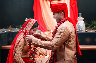 Buy stock photo Wedding, marriage and flowers with a couple together in celebration of love at a ceremony. Happy, romance or islamic with a hindi bride and groom getting married outdoor in tradition of their culture