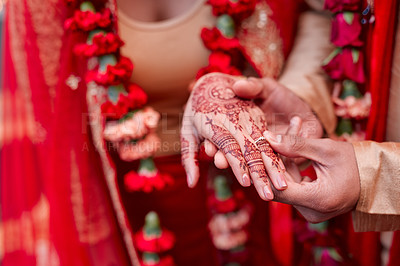 Buy stock photo Cropped shot of a hindu couple exchanging rings on their wedding day