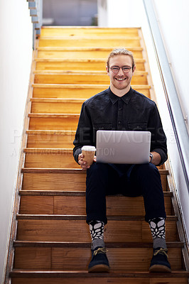 Buy stock photo Full length portrait of a handsome young businessman sitting alone on the staircase alone and using his laptop