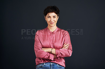 Buy stock photo Cropped portrait of an attractive young businesswoman standing alone with her arms folded against a black background in the studio