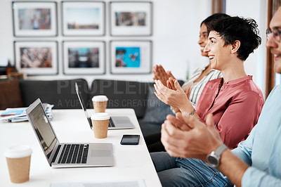 Buy stock photo Cropped shot of a diverse group of businesspeople sitting together and clapping after a successful meeting in the office