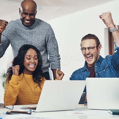 Buy stock photo Cropped shot of a group of cheerful businesspeople looking at a laptop screen together while cheering in excitement inside of the office