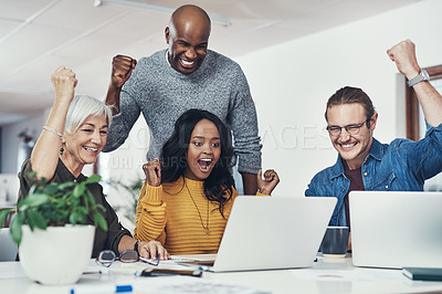 Buy stock photo Cropped shot of a group of cheerful businesspeople looking at a laptop screen together while cheering in excitement inside of the office