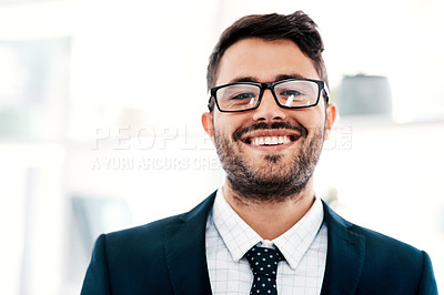 Buy stock photo Cropped portrait of a handsome young businessman smiling while standing in a modern office