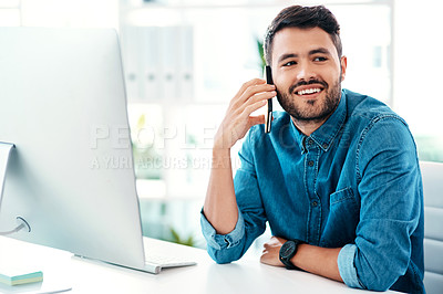 Buy stock photo Cropped shot of a handsome young businessman looking contemplative while taking a phonecall in an office