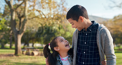Buy stock photo Shot of an adorable brother and sister having a fun day at the park