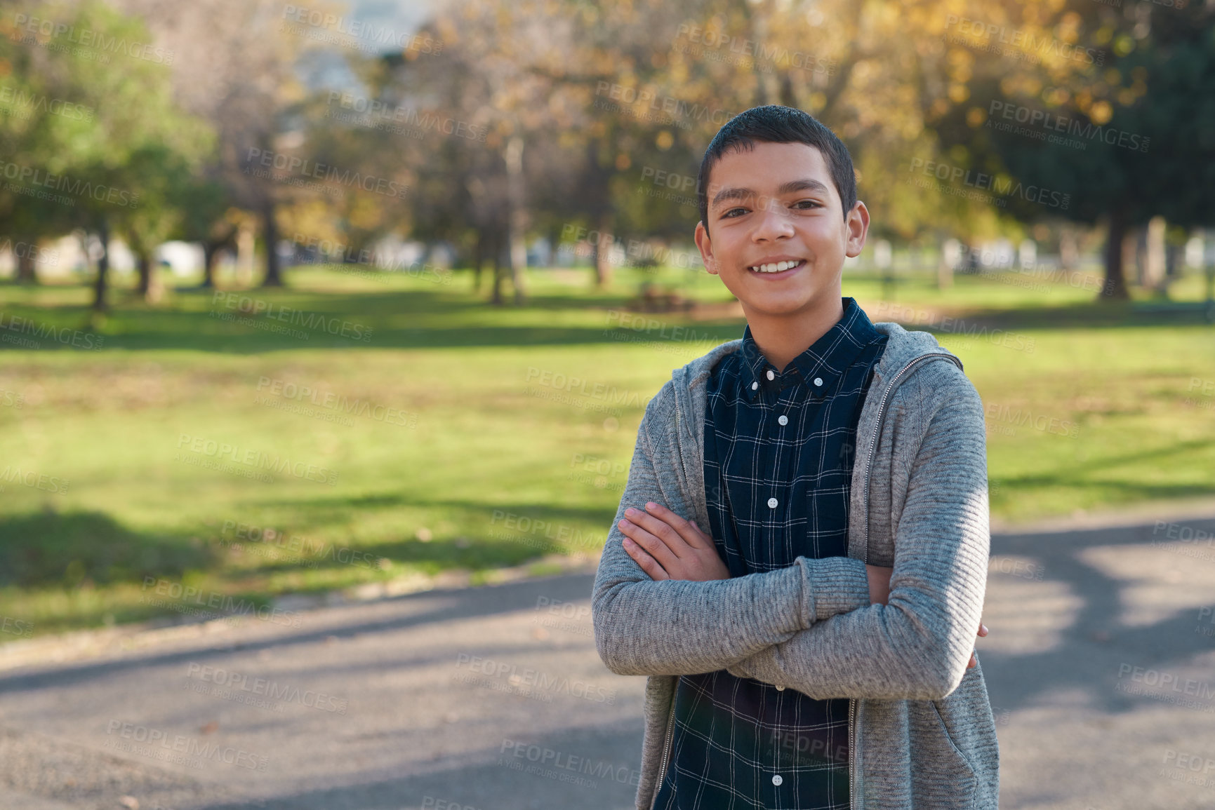 Buy stock photo Portrait, kid in nature and arms crossed, smile and vacation outdoor. Face, happiness and confident boy or child from New York having fun or enjoying winter holiday travel at park or garden and trees