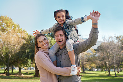 Buy stock photo Shot of an adorable little girl having fun with her parents at the park