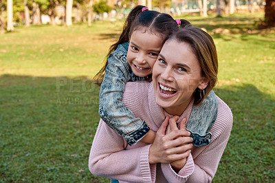 Buy stock photo Shot of an adorable little girl embracing her mother at the park