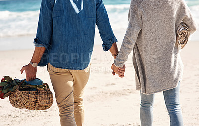 Buy stock photo Couple, beach and holding hands in walking, back and holiday for vacation, ocean and cropped shot.  Romantic, summer and picnic basket in bali, bonding and sea or outdoor, mockup and romance on sand