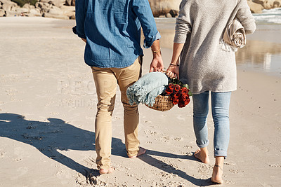Buy stock photo Cropped shot of an unrecognizable couple walking together on the beach