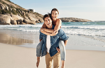 Buy stock photo Couple, portrait and piggyback with smile at beach in summer sunshine for love, romance and bond for travel. Man, woman and happy with hug, ocean waves and trust in nature, outdoor and sea holiday