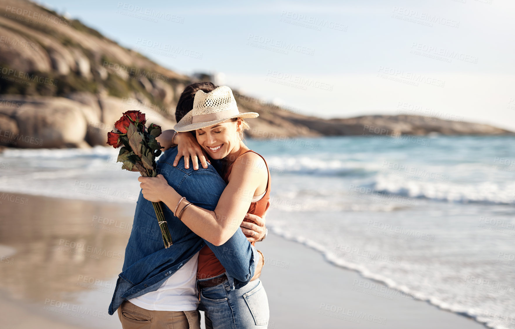 Buy stock photo Love, couple and flowers on beach with hug, anniversary and surprise by ocean for holiday in Bali. Happy, lovers and embrace on seaside with roses for romance, honeymoon and care for adventure