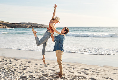 Buy stock photo Happy, lifting and couple at beach with love, summer and travel for vacation by ocean. Man, woman and hug at sea on sand with romance, smile and freedom or peace for holiday by water in Greece