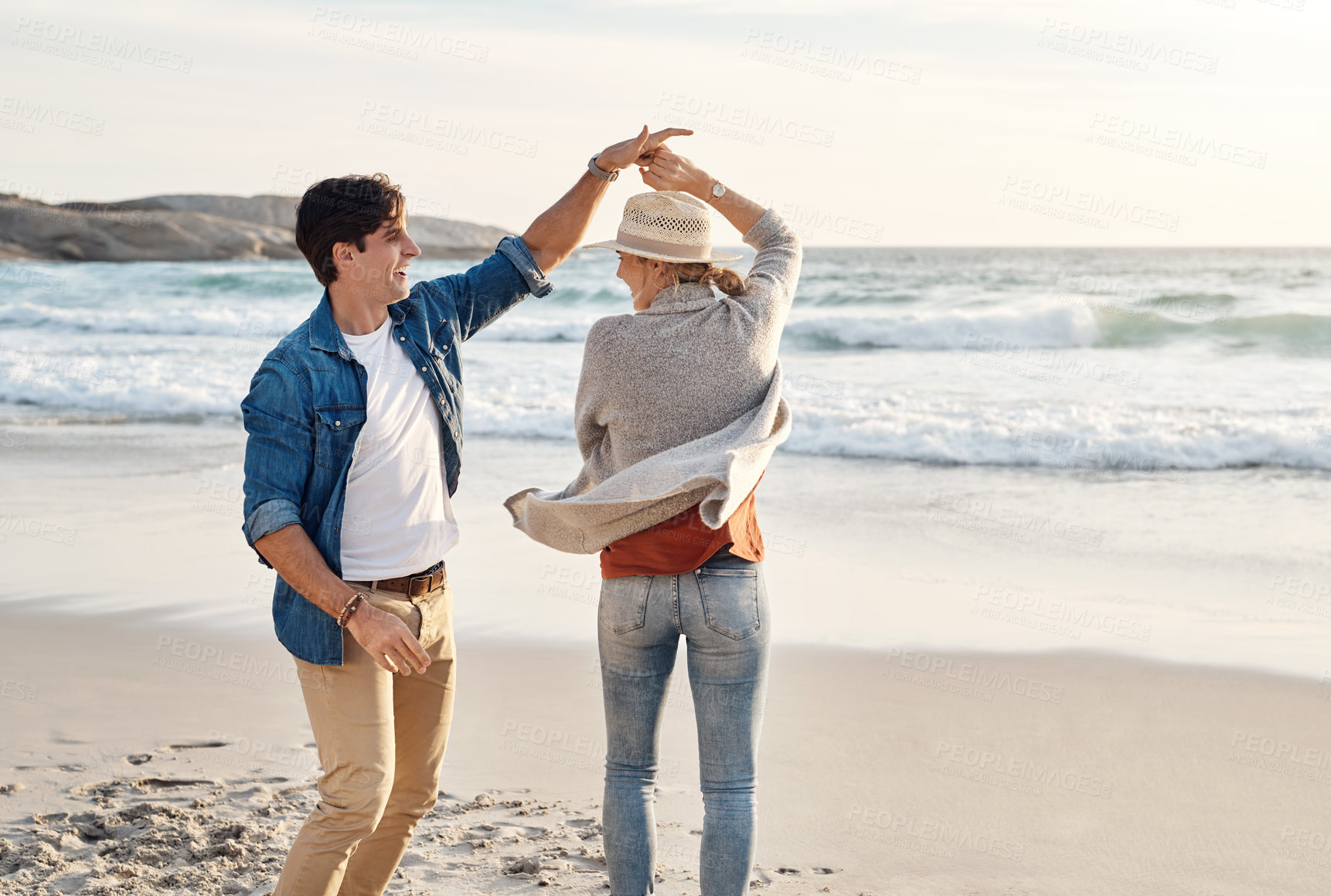 Buy stock photo Couple, dancing and happy together on beach, seaside and holiday for relationship bonding and love or affection. Ocean, calm and fun with partners on vacation trip, relax and movement for joy on date
