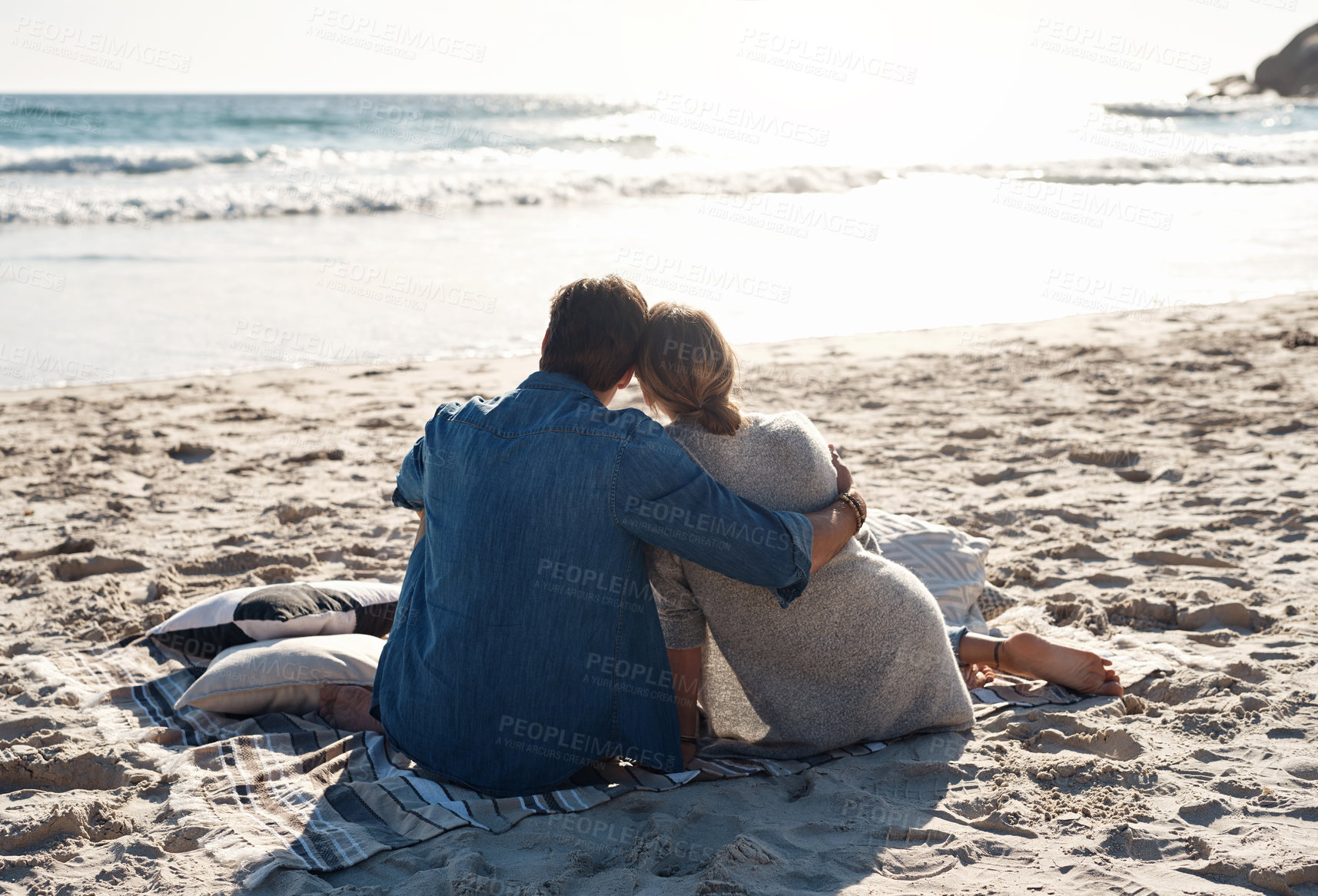 Buy stock photo Rearview shot of a middle aged couple sitting on the beach