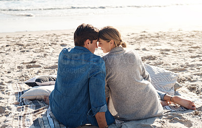 Buy stock photo Rearview shot of a middle aged couple sitting on the beach