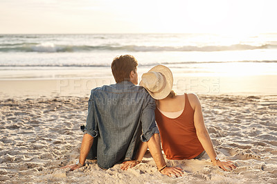 Buy stock photo Couple, vacation or beach trip sitting on blanket for picnic or relaxing on seashore getaway. Love, man and woman together happy in nature by ocean for romantic date, sunset or holiday in California