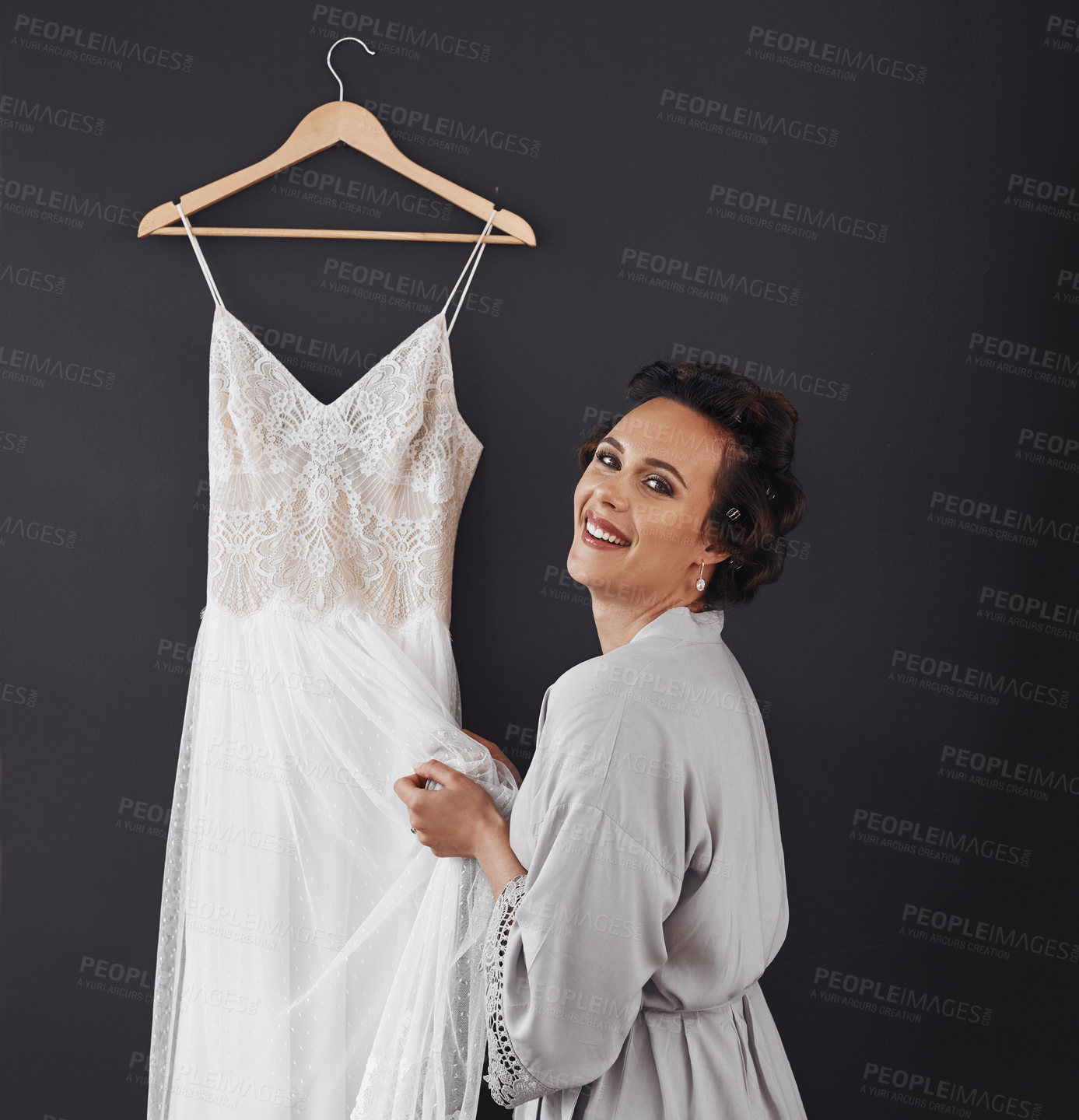 Buy stock photo Cropped shot of a woman getting ready to put on her wedding dress