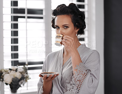 Buy stock photo Cropped shot of a woman drinking tea while getting ready